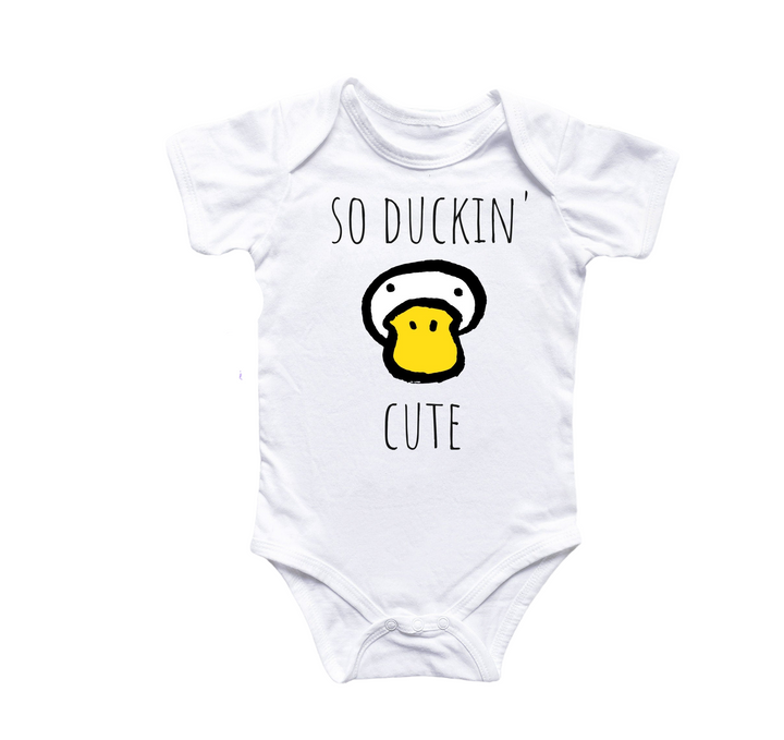 a white bodysuit with a yellow duck on it