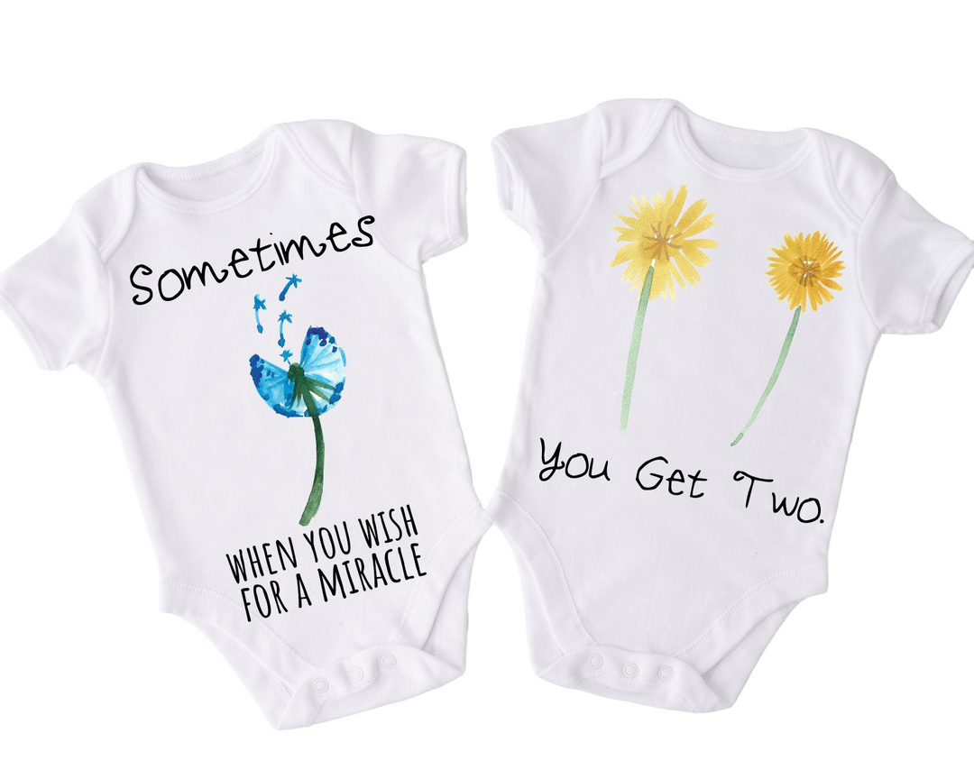 two baby onesuits with flowers and butterflies on them