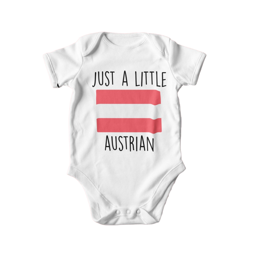 a baby bodysuit with the words just a little austrian on it
