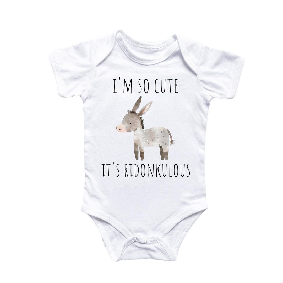 a white baby bodysuit with a picture of a donkey