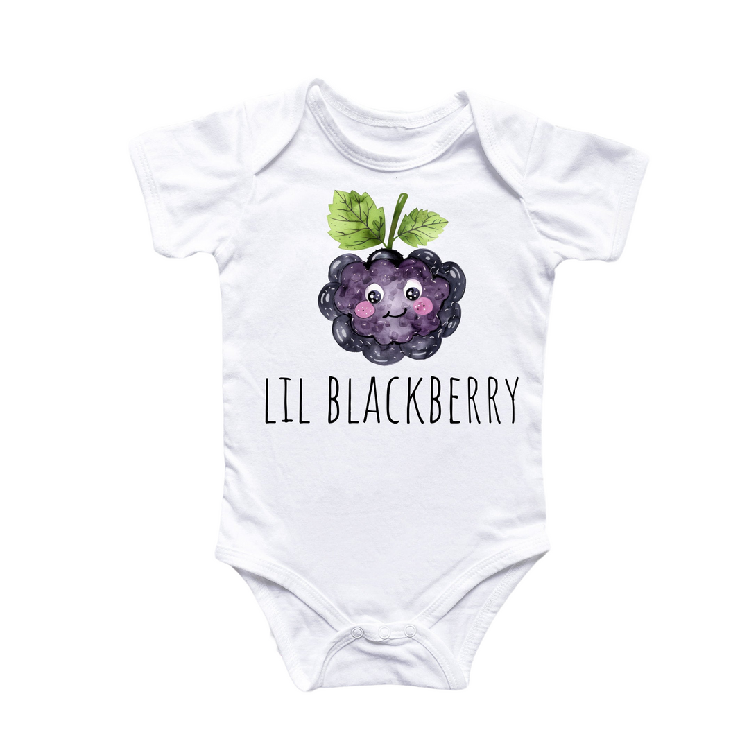 a white bodysuit with a black berry on it