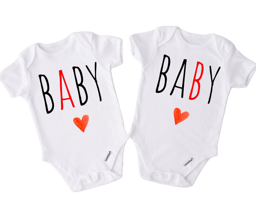 two baby onesuits with hearts on them