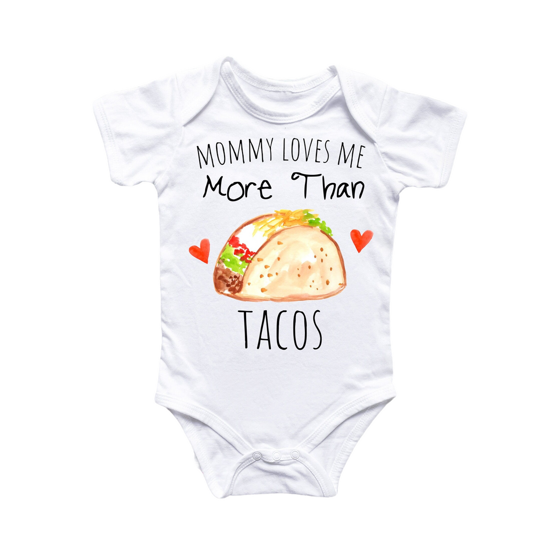 a baby bodysuit that says mommy loves me more than tacos