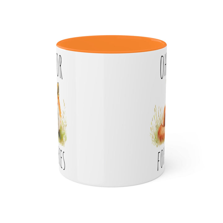 a white coffee mug with an orange rim