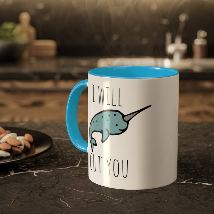 a blue and white coffee mug sitting on top of a counter