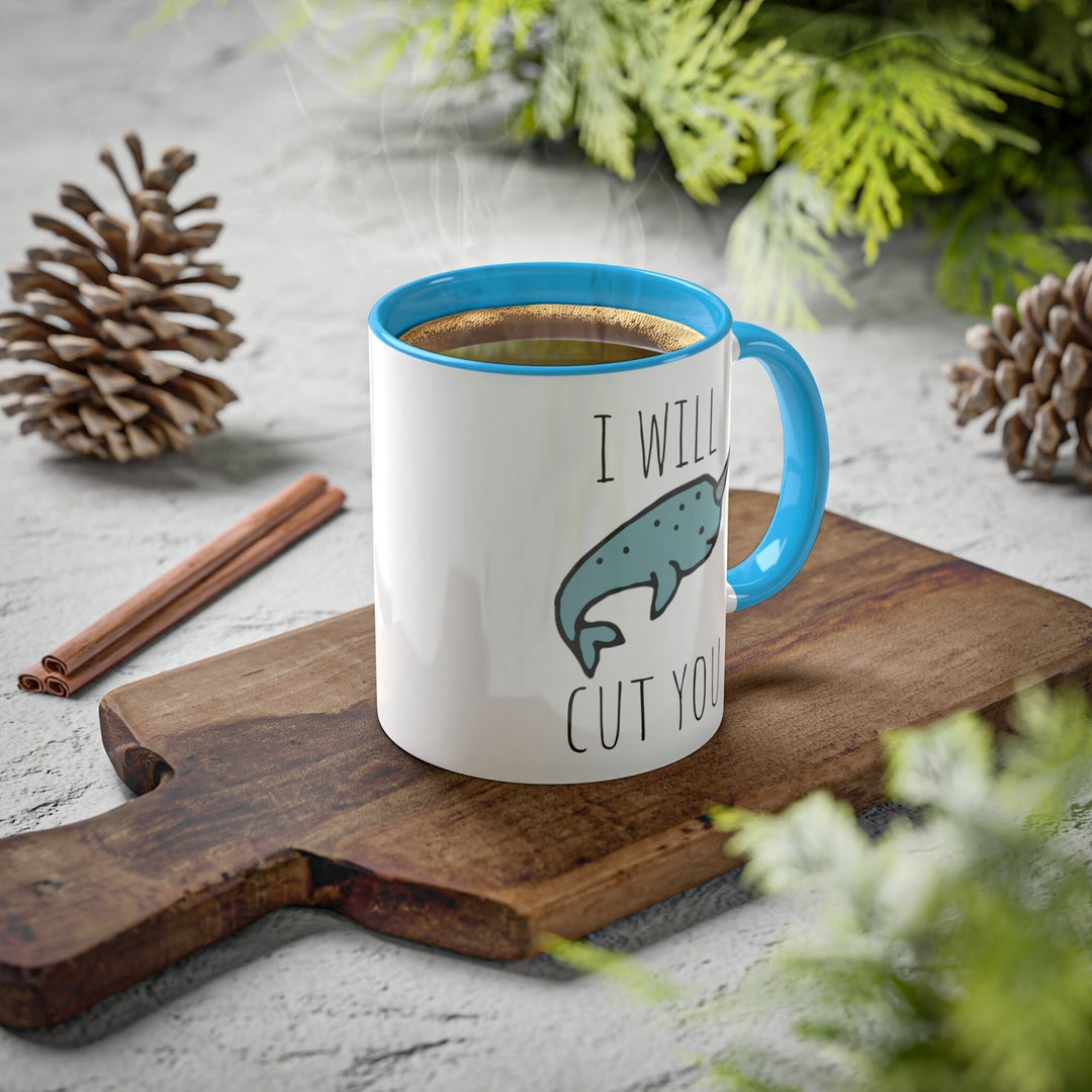 a blue and white coffee mug sitting on top of a wooden cutting board