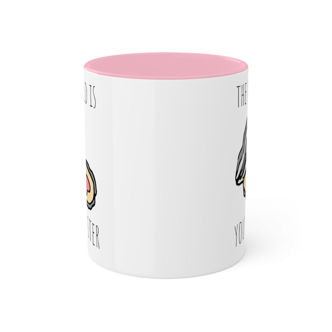 a pink and white coffee mug with a donut on it