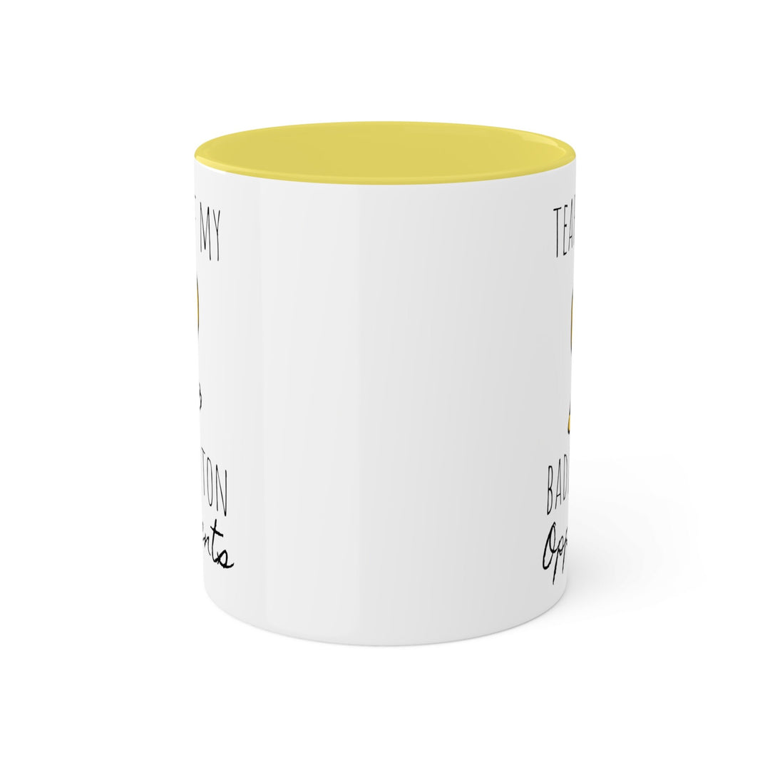 a white coffee mug with a yellow rim