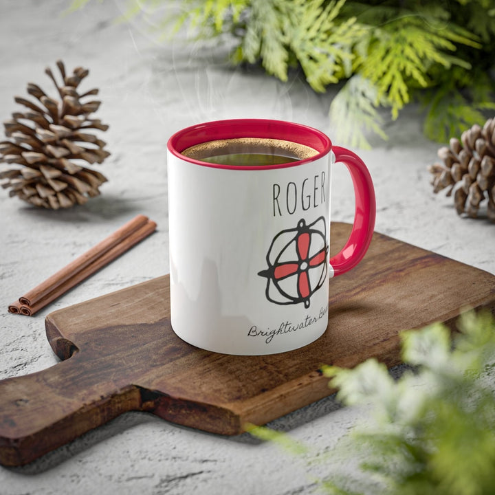 a red and white coffee mug sitting on top of a wooden cutting board