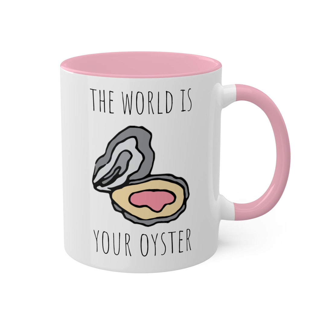 a pink and white coffee mug with the words the world is your oyster on it