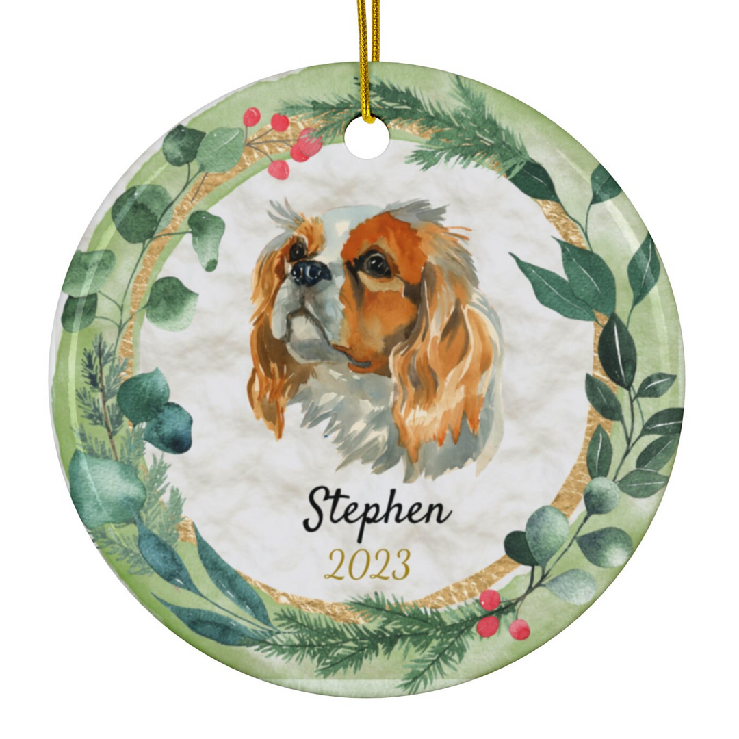 a ceramic ornament with a dog and a wreath on it