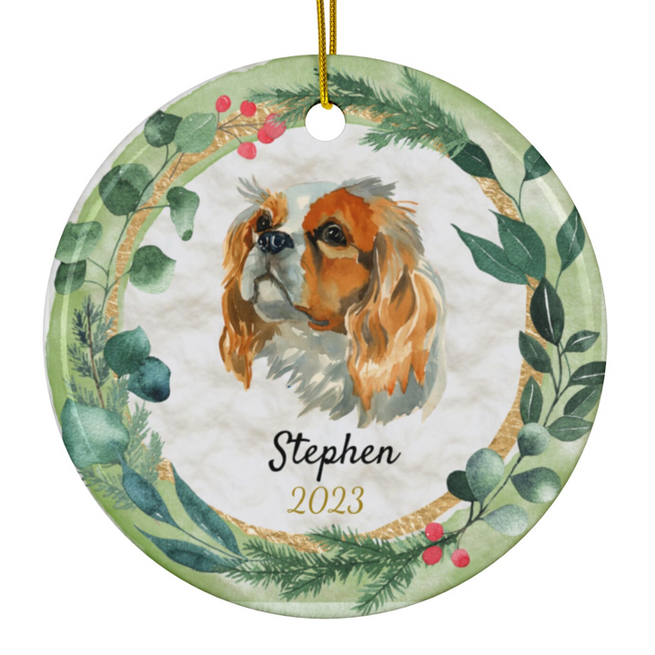 a ceramic ornament with a dog and a wreath on it