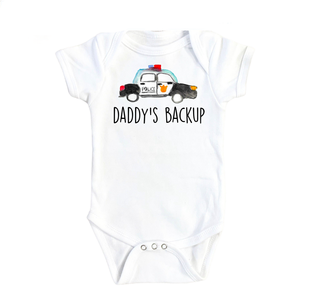a baby bodysuit that says daddy's backup with a police car on it