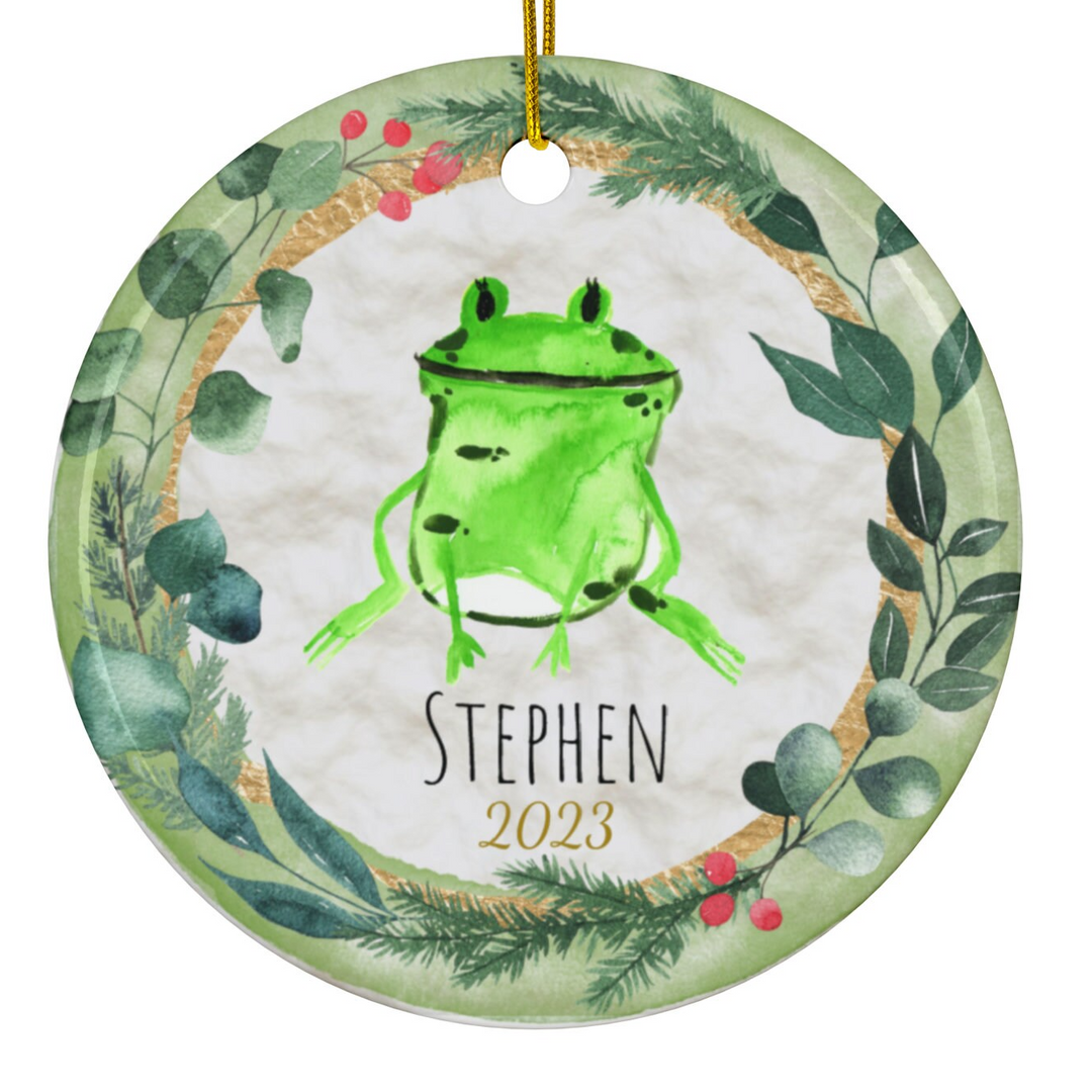 a green ornament with a picture of a frog on it